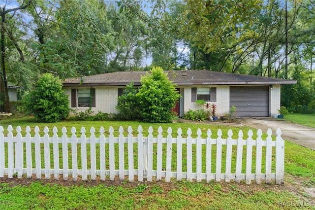 single story home with a garage and a front lawn