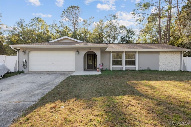 ranch-style home featuring a garage and a front lawn