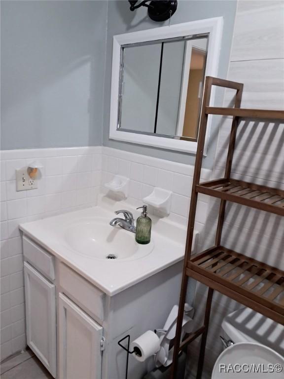 bathroom featuring tile patterned flooring and vanity