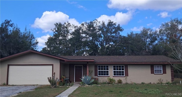 single story home featuring a garage and a front yard