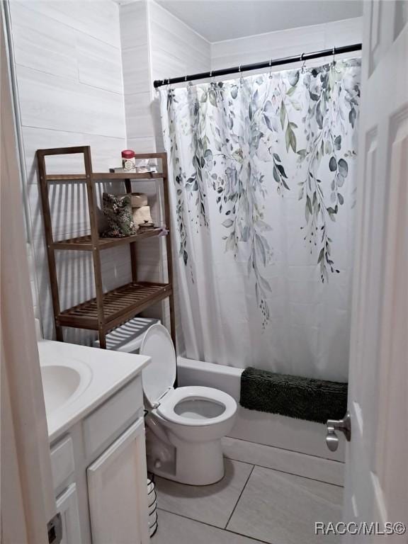 full bathroom with tile patterned flooring, shower / bath combo, vanity, and toilet