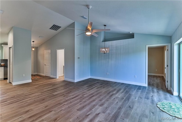 unfurnished living room featuring ceiling fan with notable chandelier, wood finished floors, and visible vents