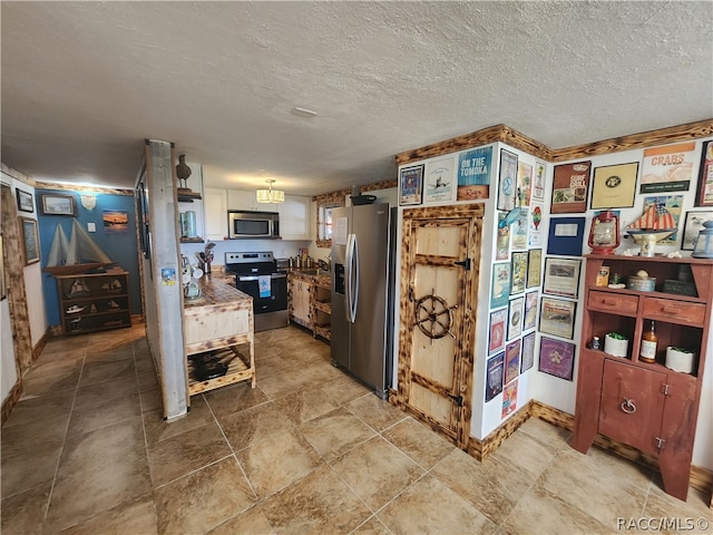 kitchen featuring stainless steel appliances and a textured ceiling