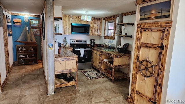 kitchen featuring sink, hanging light fixtures, and appliances with stainless steel finishes