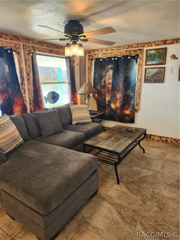 living room with ceiling fan and a textured ceiling