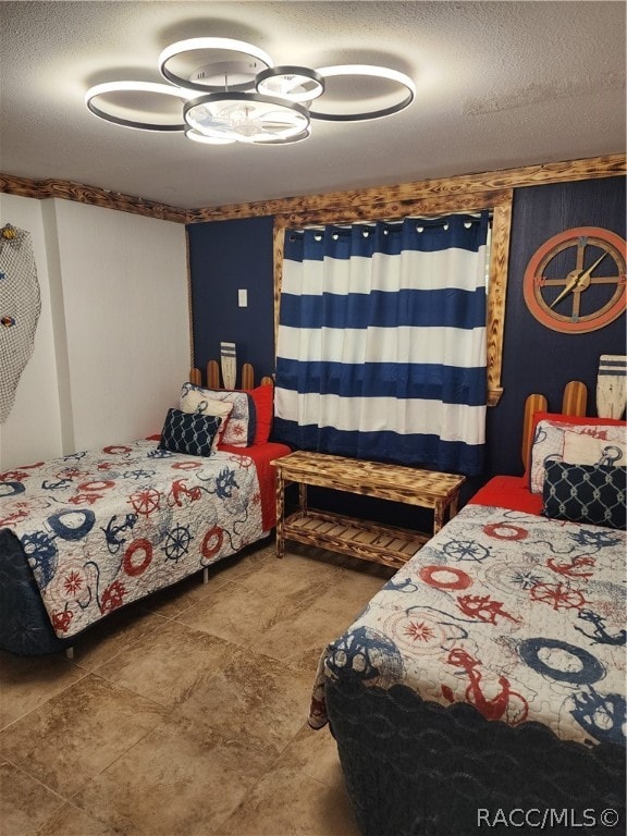 bedroom with a textured ceiling and ceiling fan