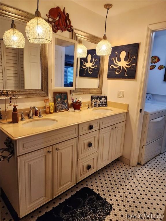 bathroom featuring vanity, washer / clothes dryer, and tile patterned floors