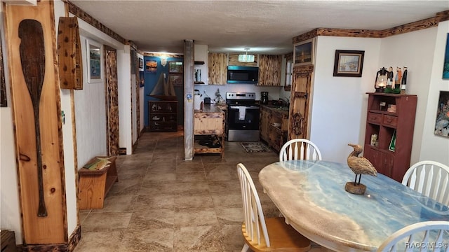 dining space with sink and a textured ceiling