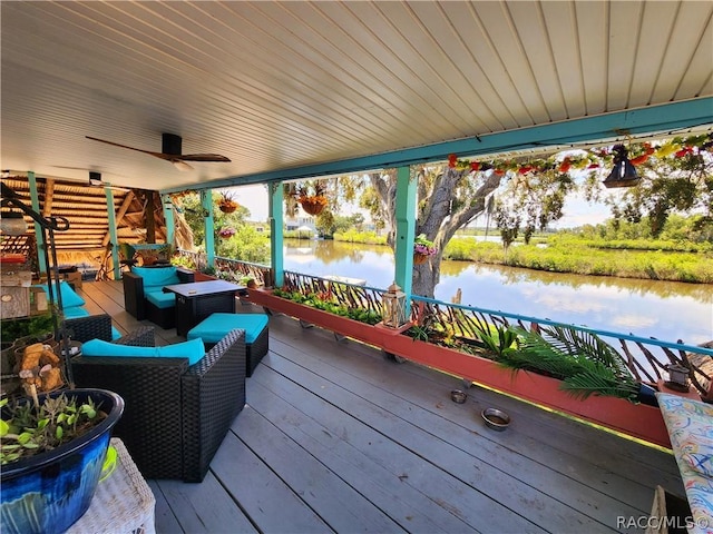 wooden terrace with outdoor lounge area and a water view