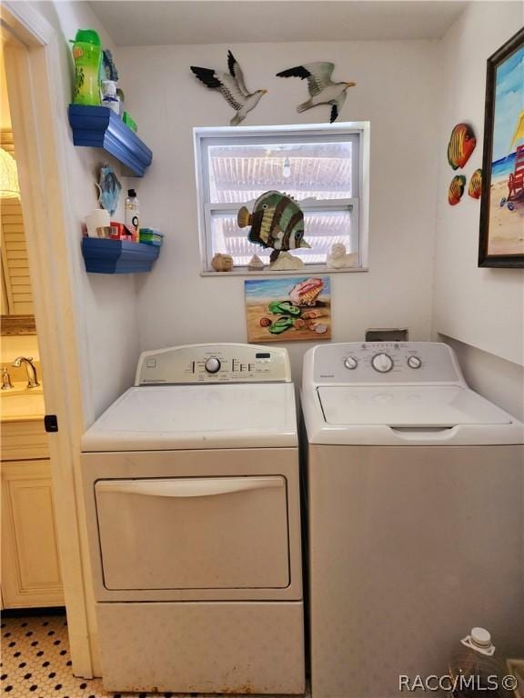 washroom featuring washer and clothes dryer and sink