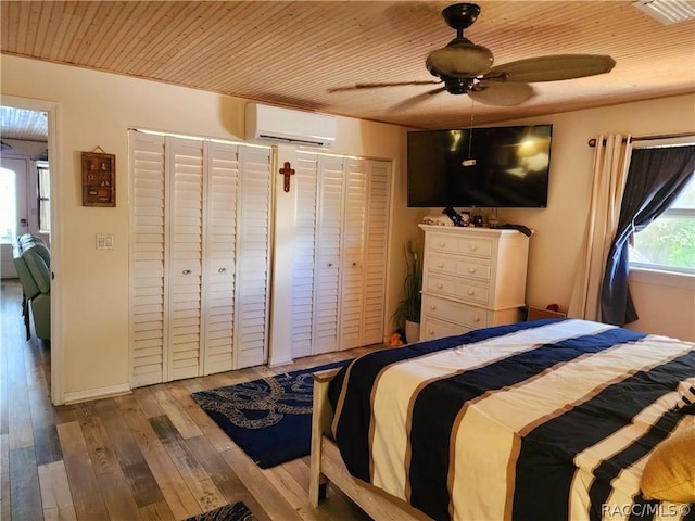 unfurnished bedroom with a wall mounted AC, ceiling fan, and light hardwood / wood-style flooring