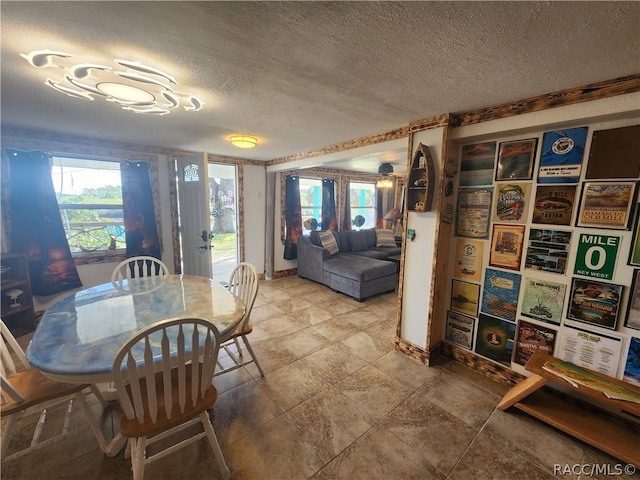 dining space with french doors and a textured ceiling