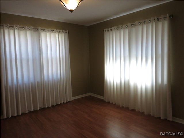 spare room featuring dark hardwood / wood-style floors