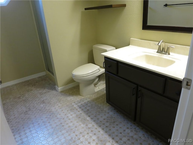 bathroom with vanity, an enclosed shower, and toilet