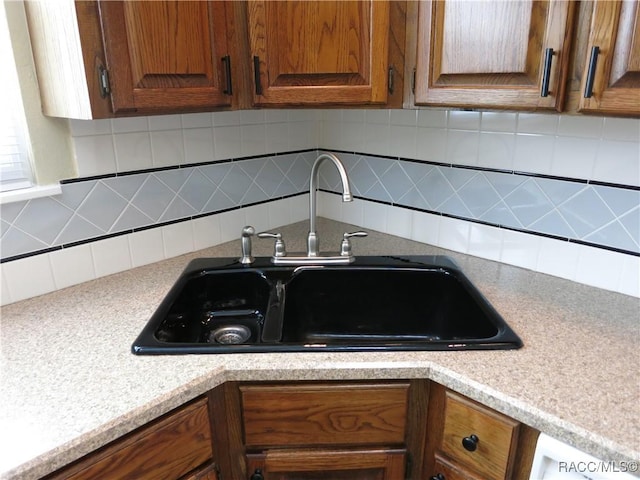 kitchen with tasteful backsplash and sink