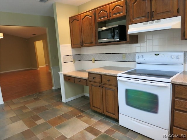 kitchen with white electric stove and decorative backsplash