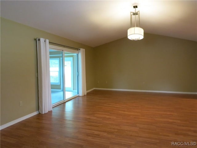 empty room with lofted ceiling and dark hardwood / wood-style floors