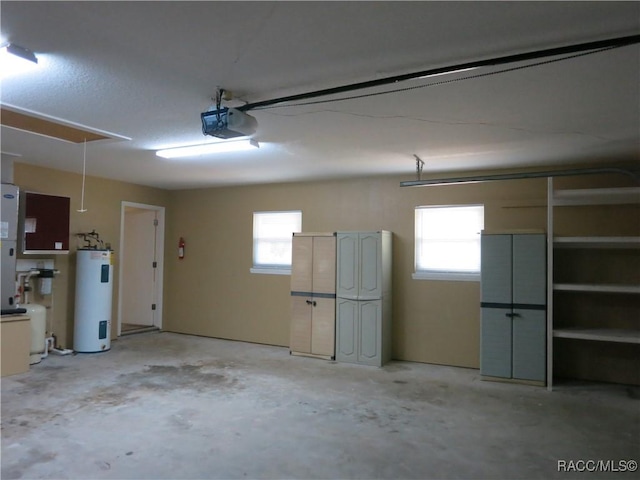 garage with a garage door opener and electric water heater