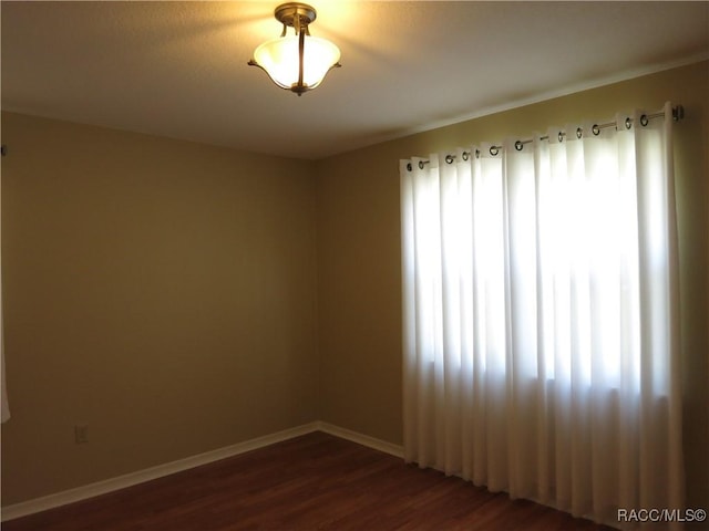 empty room with dark wood-type flooring