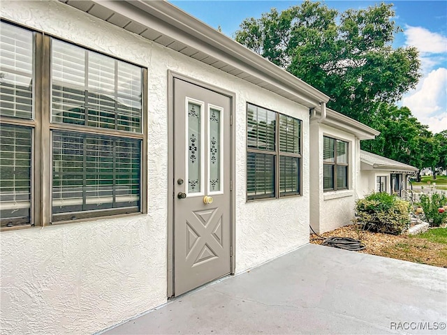 3328 S Whitechappel Pt, Inverness, FL 34452 - entrance to property with stucco siding and a patio