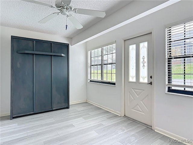 3328 S Whitechappel Pt, Inverness, FL 34452 - foyer featuring a textured ceiling, light wood-type flooring, plenty of natural light, and ceiling fan