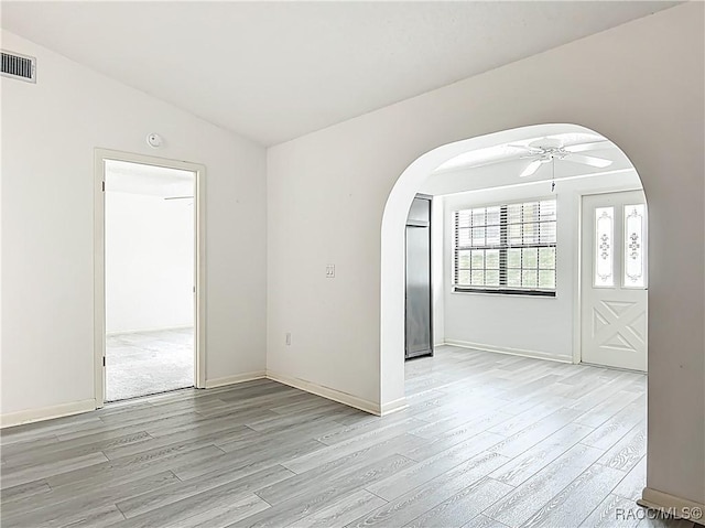 3328 S Whitechappel Pt, Inverness, FL 34452 - spare room with arched walkways, light wood-type flooring, and ceiling fan