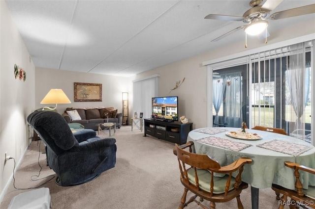 carpeted living room featuring ceiling fan