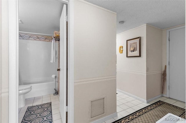 bathroom featuring shower / bathtub combination, ornamental molding, a textured ceiling, tile patterned flooring, and toilet