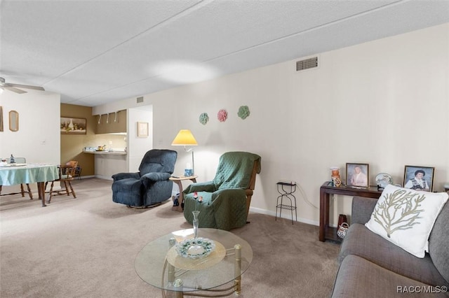 carpeted living room with ceiling fan