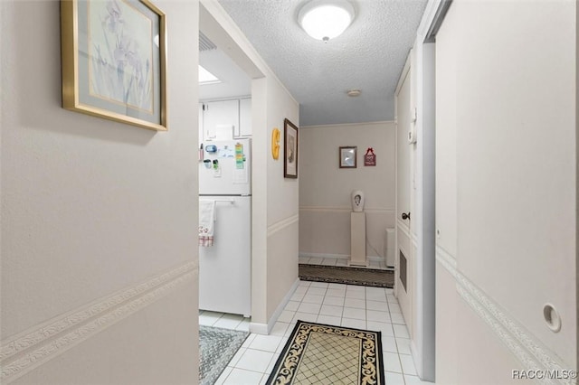 interior space with light tile patterned floors and a textured ceiling