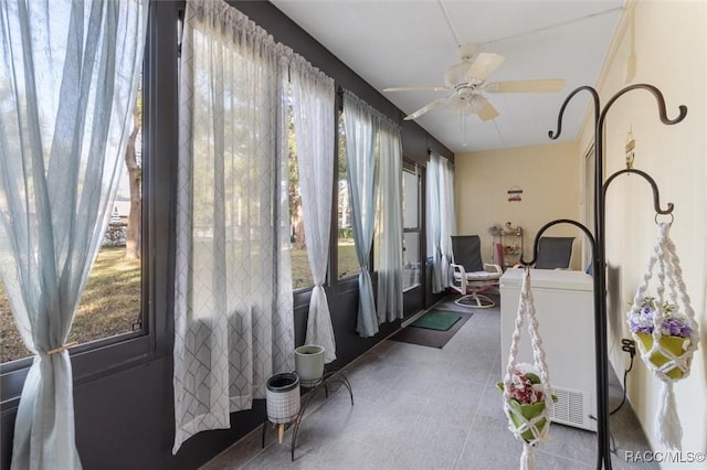 sunroom featuring ceiling fan