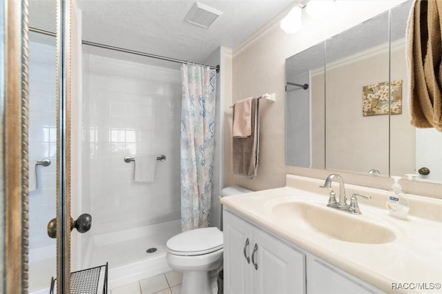 bathroom featuring tile patterned floors, toilet, vanity, and walk in shower