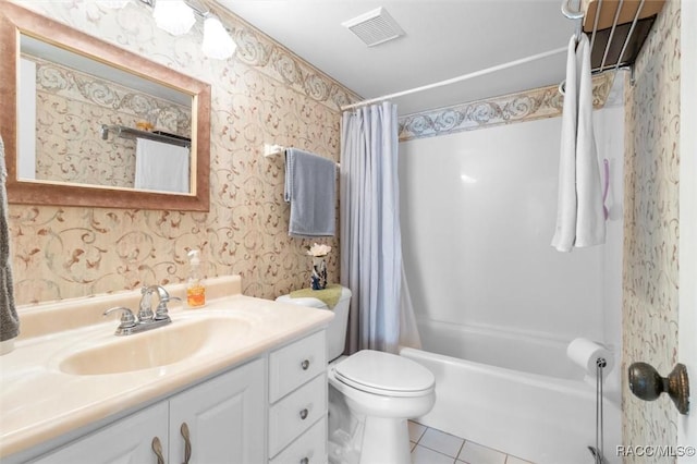 full bathroom featuring tile patterned floors, vanity, toilet, and shower / bath combo