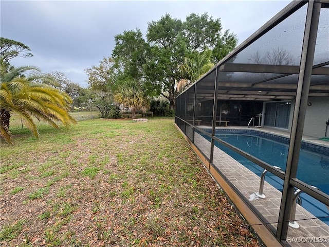 view of yard with a lanai and an outdoor pool