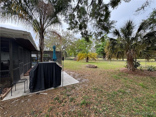 view of yard with a patio area, a fire pit, and a sunroom