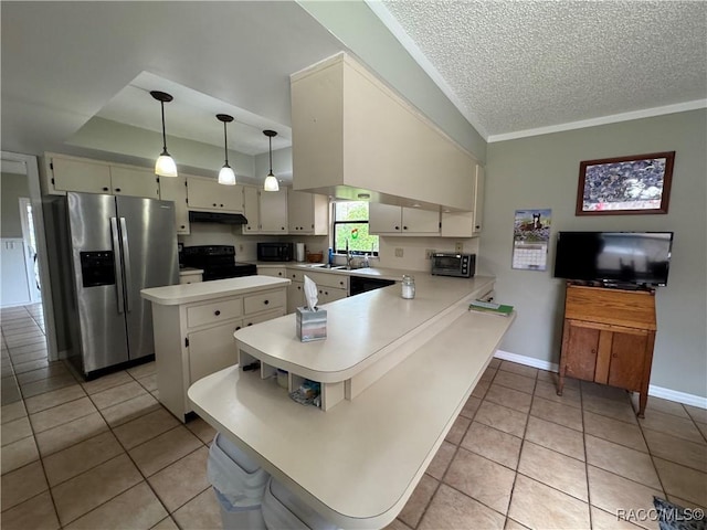 kitchen featuring under cabinet range hood, light countertops, a peninsula, black appliances, and a sink