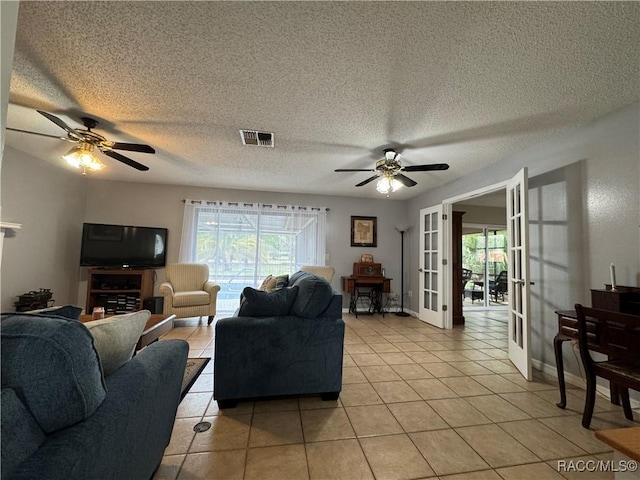 living area featuring light tile patterned flooring, visible vents, plenty of natural light, and french doors