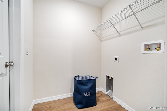 laundry room featuring hookup for an electric dryer, hookup for a washing machine, and hardwood / wood-style flooring