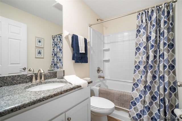 full bathroom with vanity, shower / bath combo, and toilet