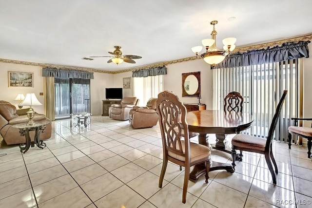 tiled dining space featuring ceiling fan with notable chandelier