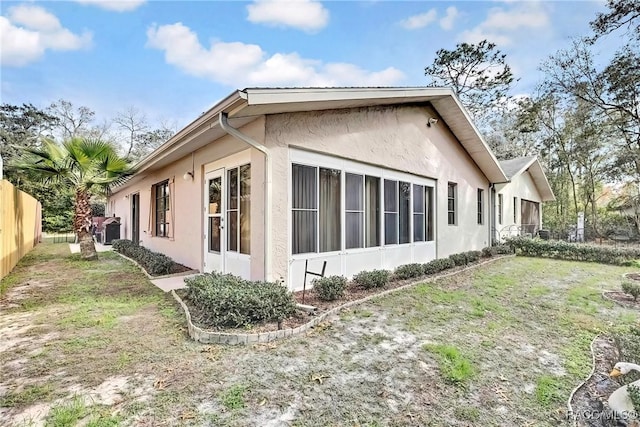 view of side of property with a lawn