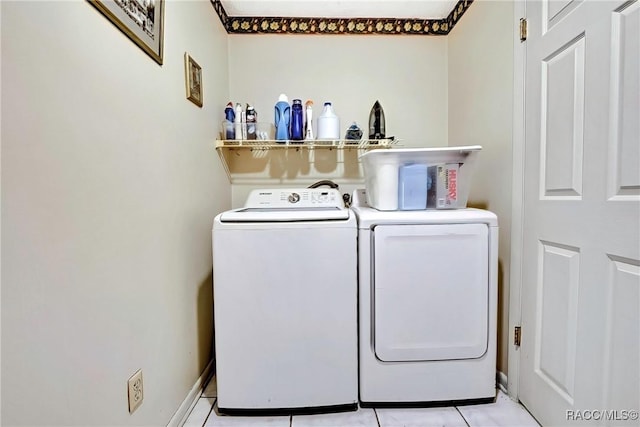 laundry area featuring light tile patterned floors and washer and dryer