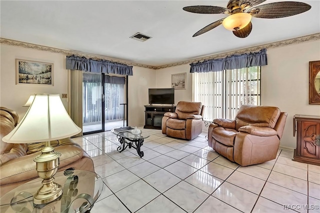 living room with plenty of natural light, light tile patterned floors, and ceiling fan