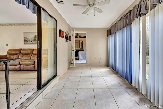 hall featuring light tile patterned floors