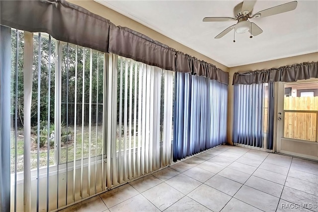 unfurnished sunroom featuring a wealth of natural light and ceiling fan