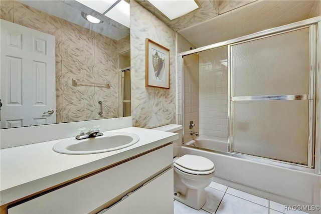 full bathroom featuring tile patterned floors, vanity, toilet, and combined bath / shower with glass door