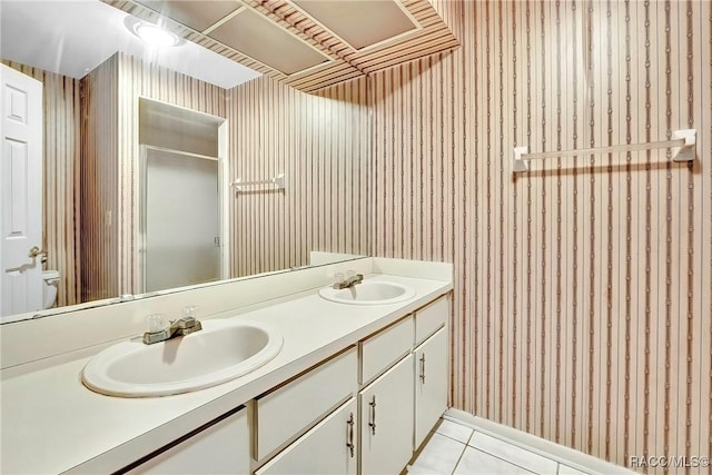 bathroom with tile patterned flooring, vanity, and toilet