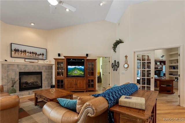 5799 N Oakmont Dr, Beverly Hills, FL 34465 - living area with a ceiling fan, light wood-style flooring, a tile fireplace, and lofted ceiling