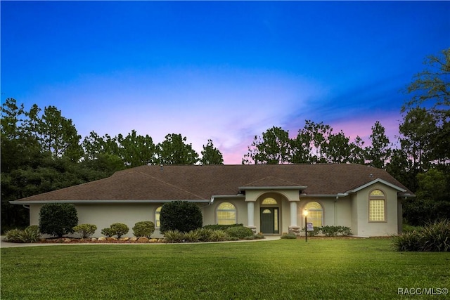 5799 N Oakmont Dr, Beverly Hills, FL 34465 - ranch-style house with stucco siding and a lawn