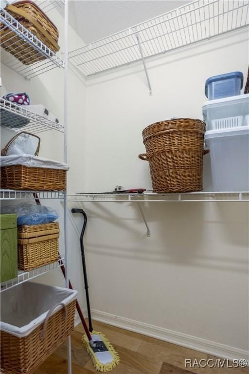 5799 N Oakmont Dr, Beverly Hills, FL 34465 - walk in closet featuring wood finished floors